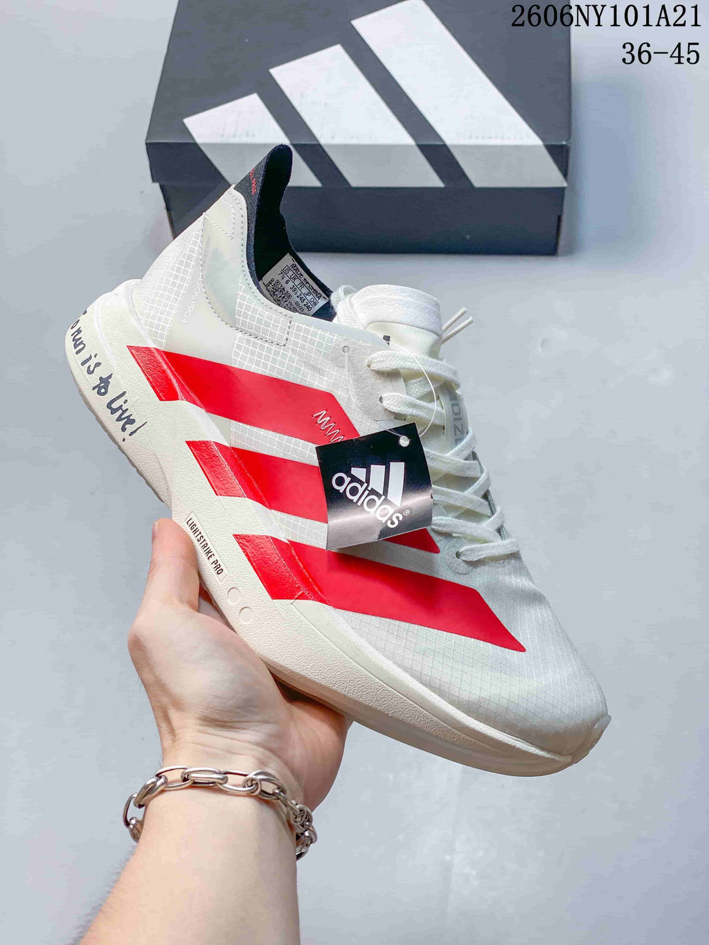 White Adidas running shoe with red stripes and Lightstrike Pro sole; image text shows 36–45.