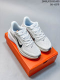 White Nike Pegasus 42 running shoes with dark accents, shown on an orange shoe box