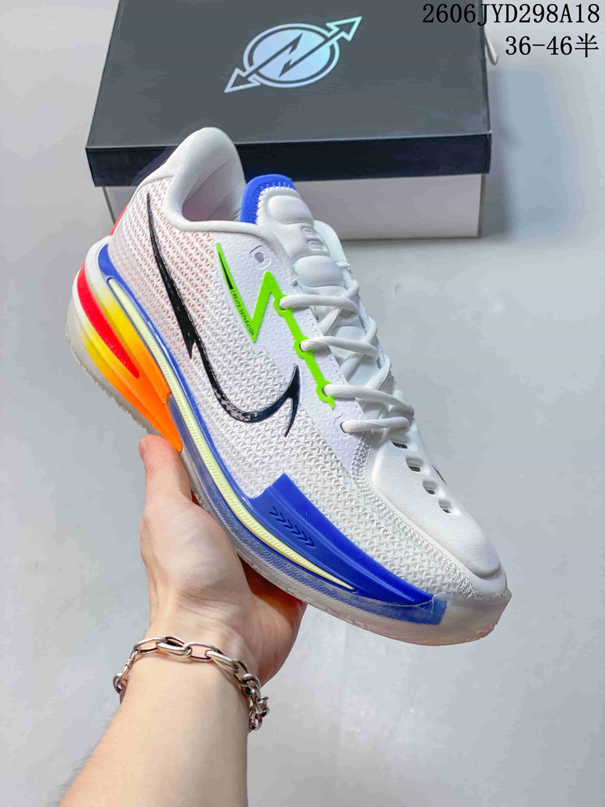 Side view highlighting the white upper, black swoosh, blue trim, and bright heel accents.