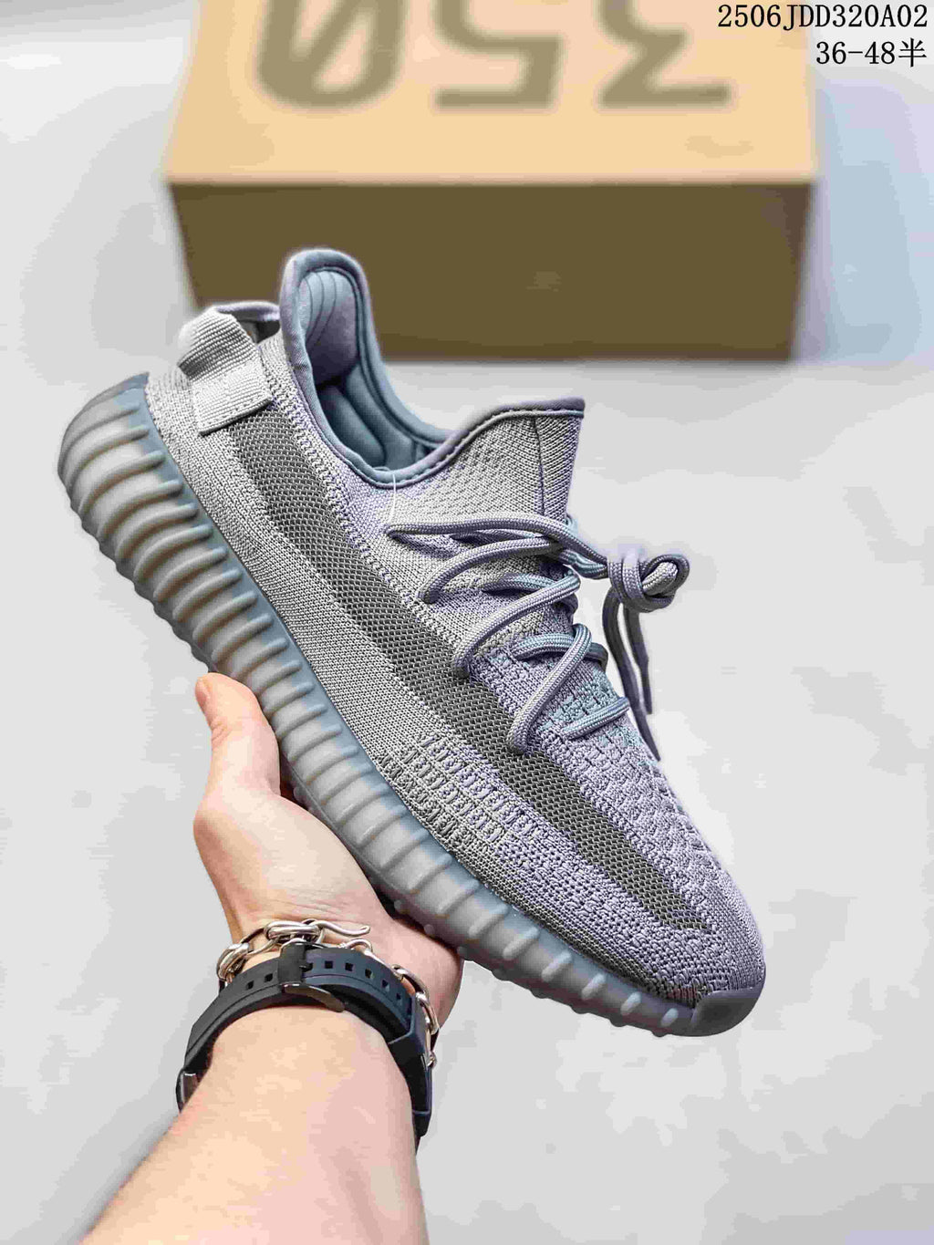 Gray knit low-top sneaker with matching laces and a ribbed gray sole.