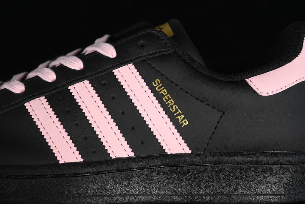 Close-up of the pink side stripes and gold Superstar lettering