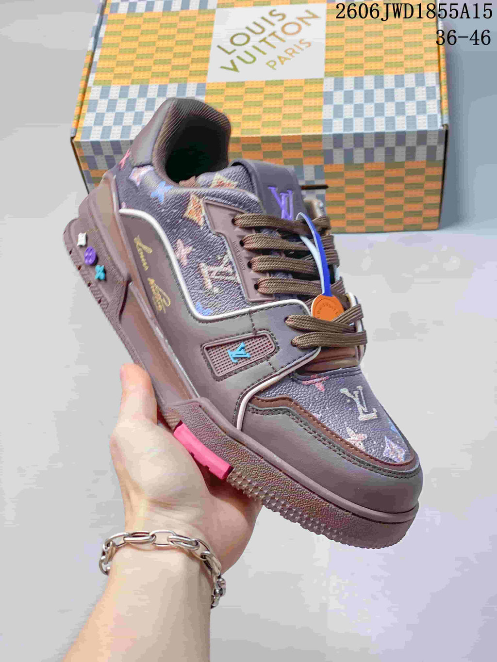 Angled side view of the sneaker highlighting its taupe panels and multicolor details.