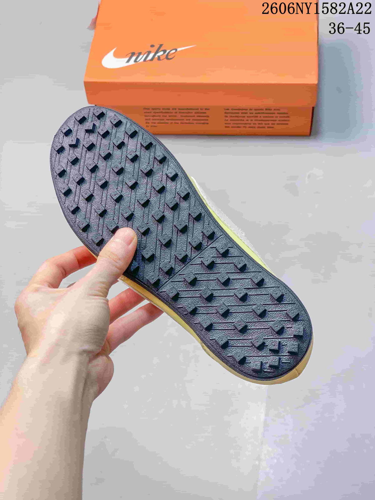 Close-up of the dark textured outsole on a Nike Moon Shoe OG sneaker