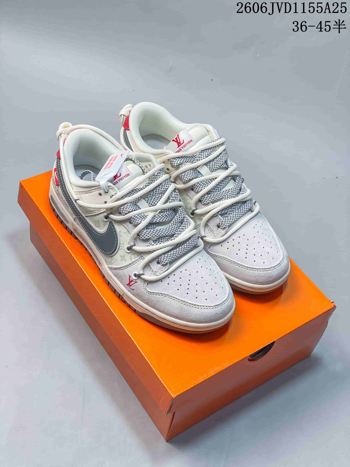 White low-top sneakers with gray patterned panels, dark swooshes, and red accents