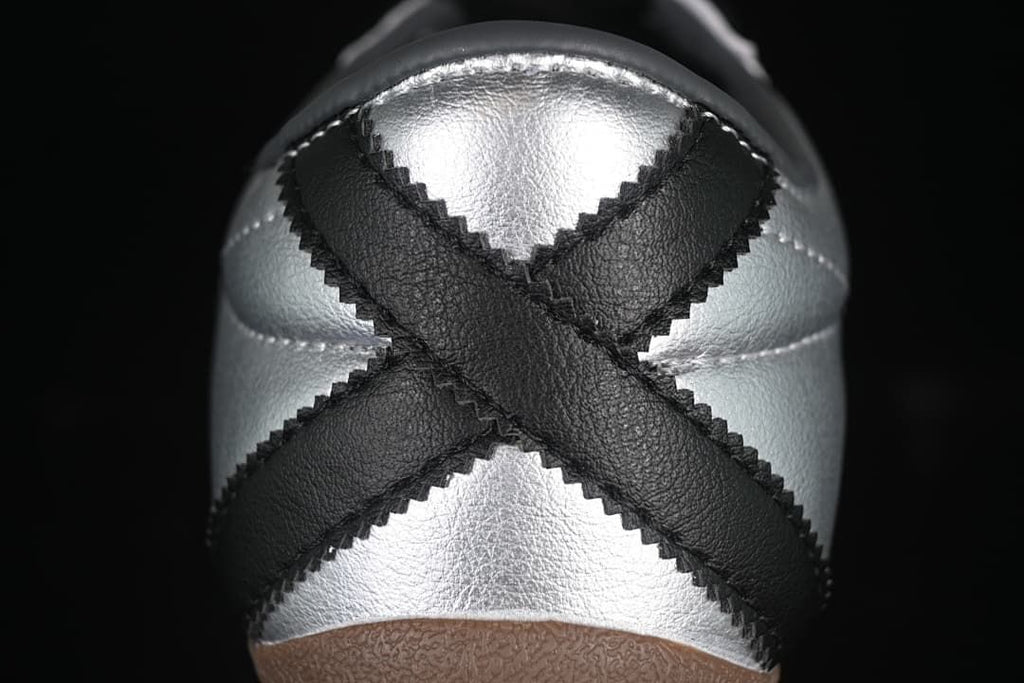 Close-up of the silver heel with crossed black overlays