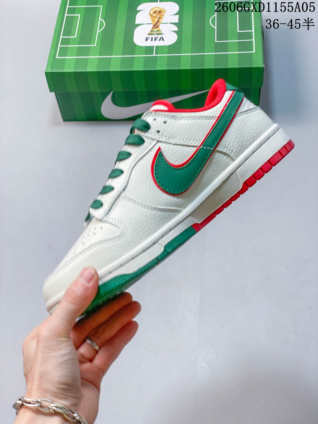 Side profile of an off-white low-top sneaker with a green side panel and red trim