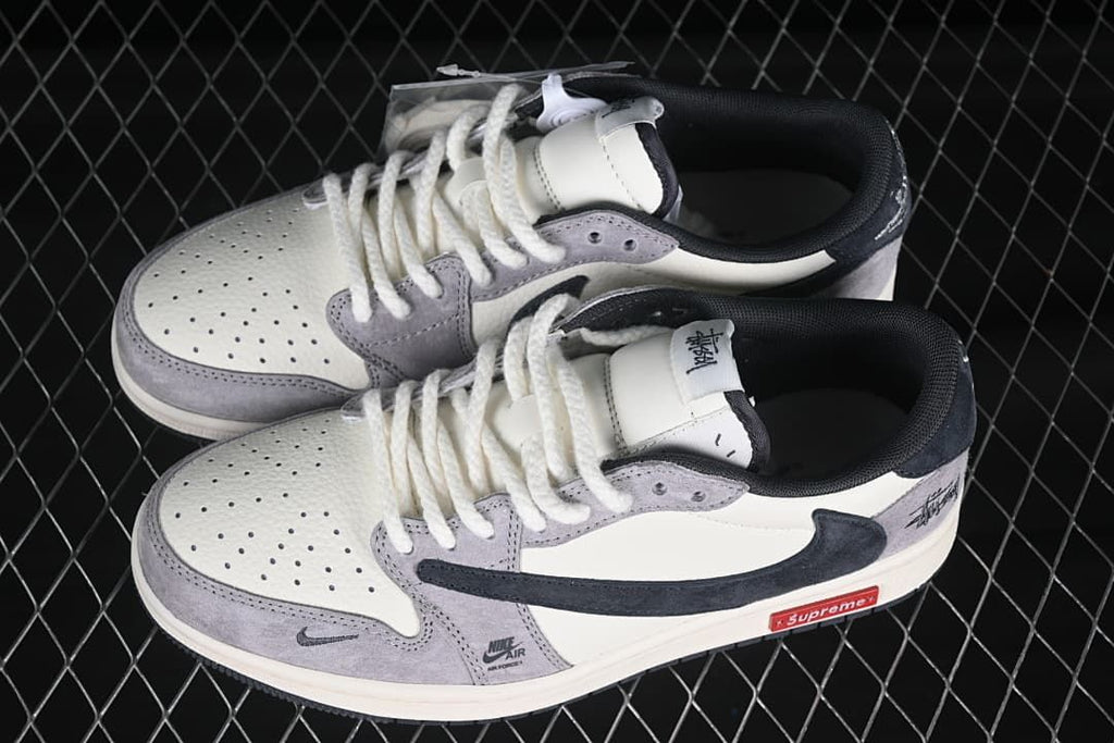 Pair of gray and off-white low-top sneakers shown from above, with perforated toes, white laces and dark lining.