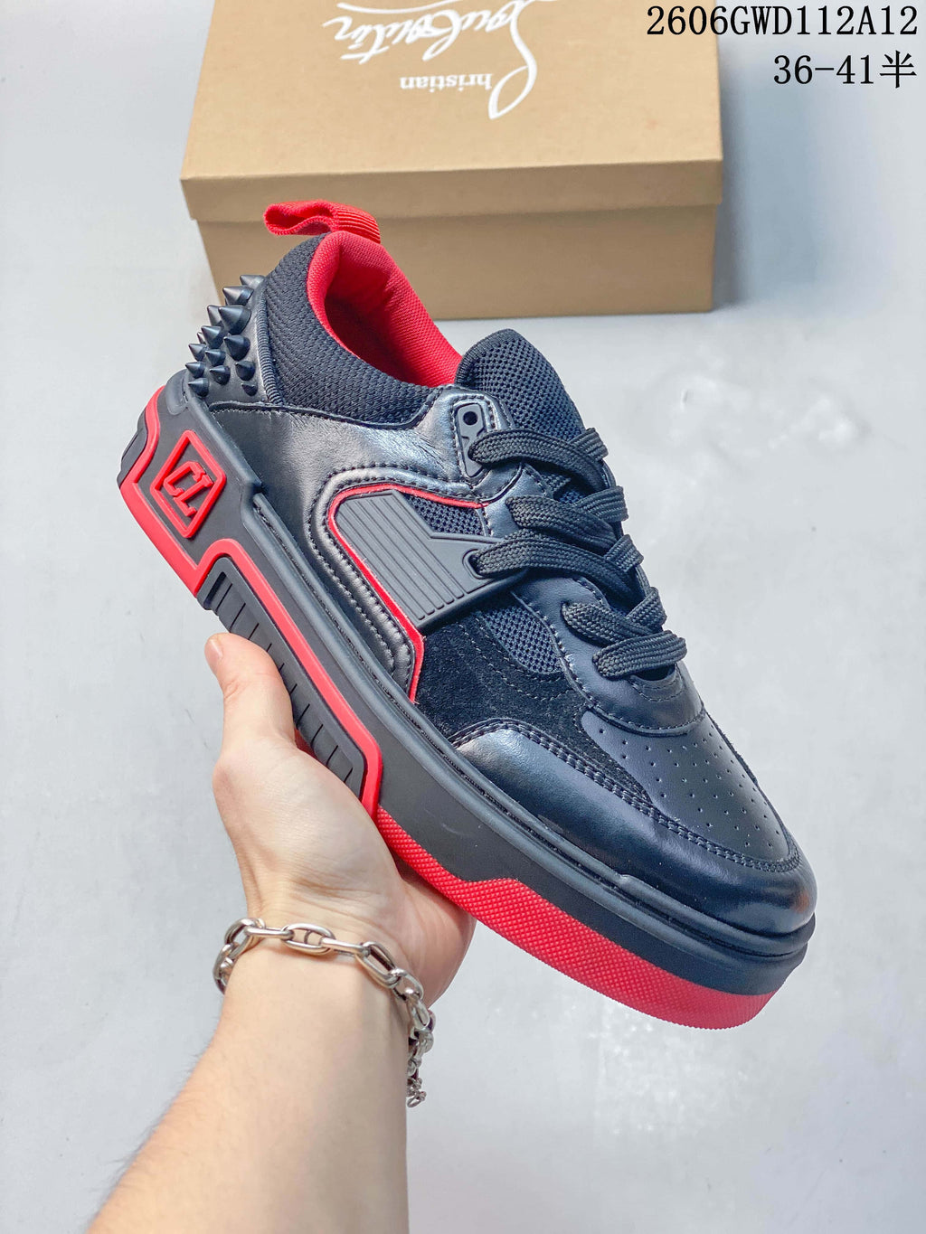Angled side view of the black and red low-top sneaker