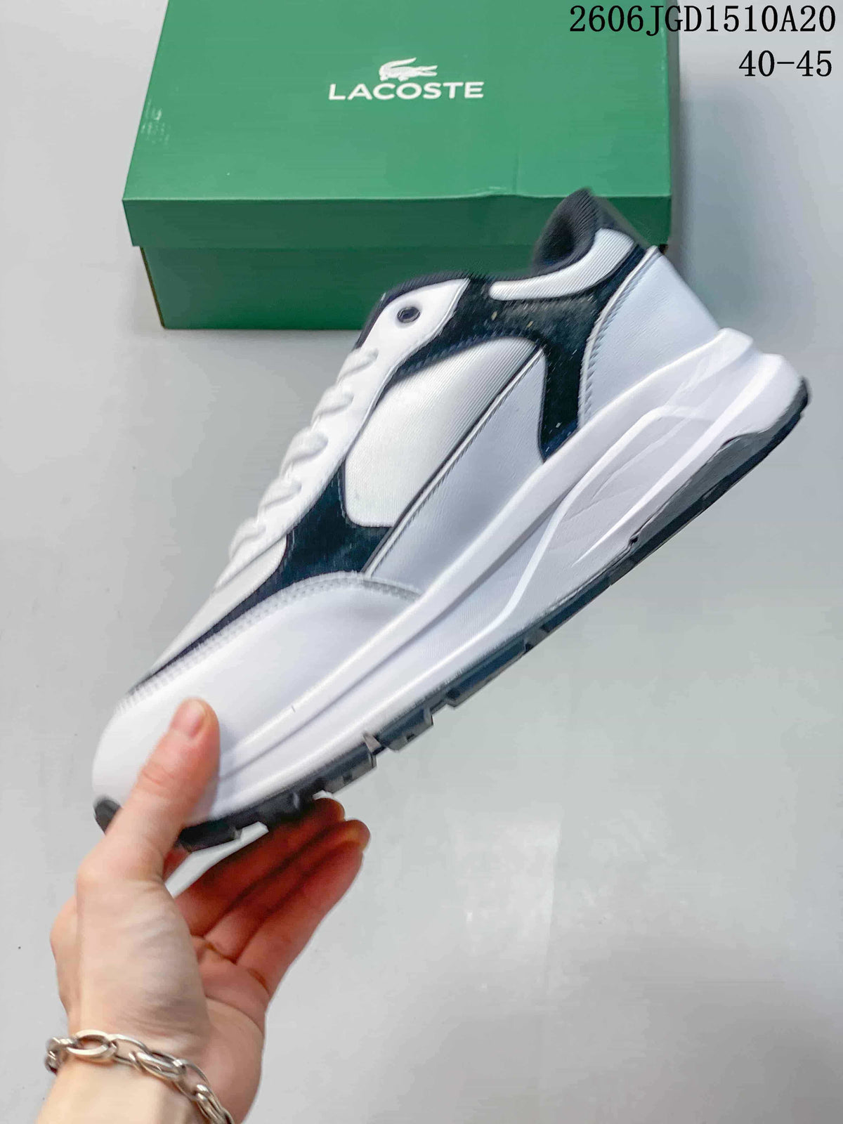 Side profile of the white and navy Lacoste sneaker with a chunky sole