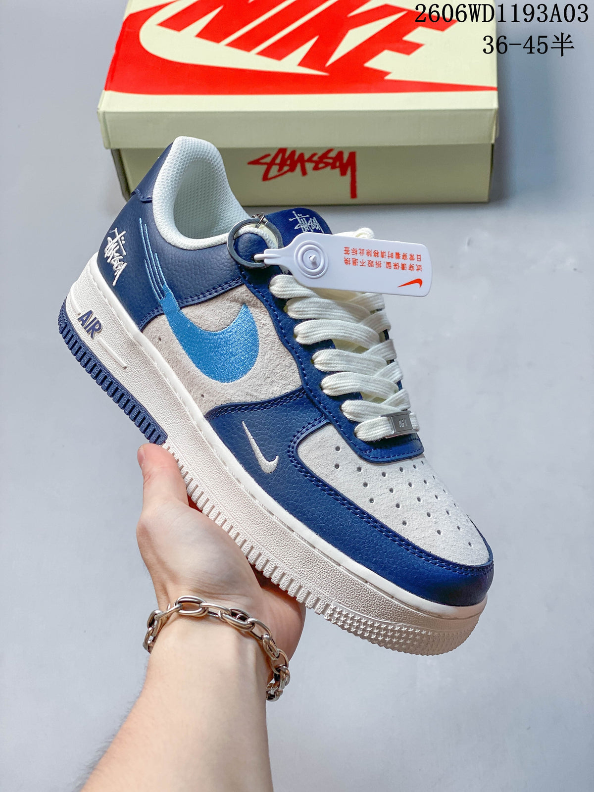 Angled side view of the blue, gray, and off-white low-top sneaker