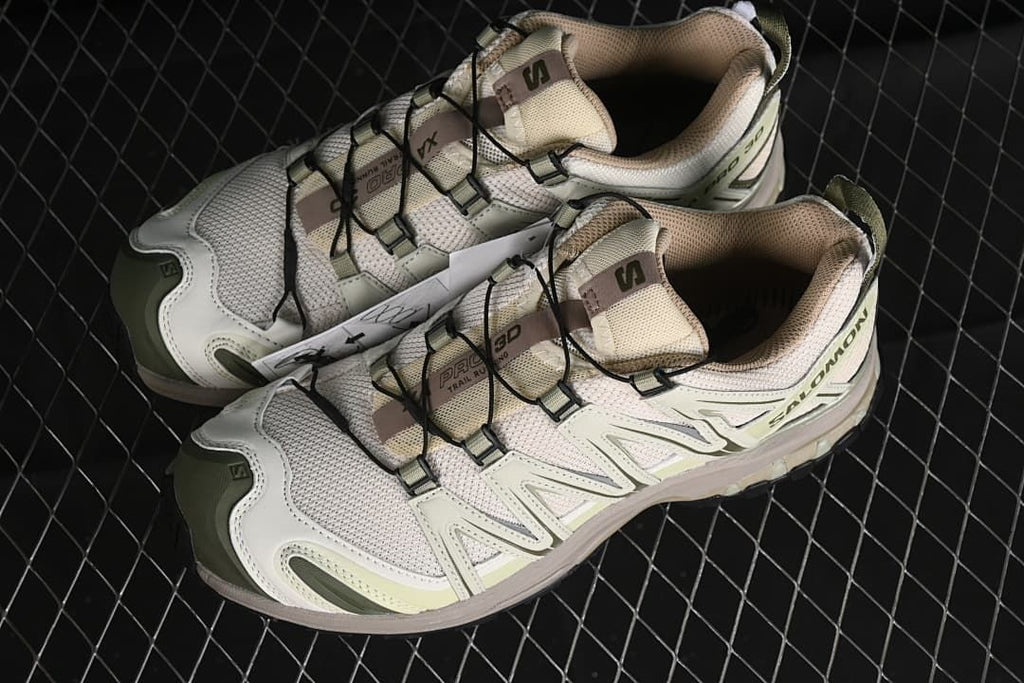 Pair of cream and green XA Pro 3D shoes viewed from above.