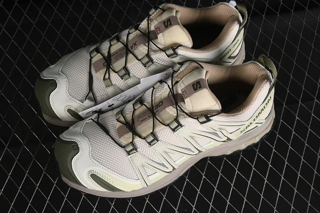 Pair of cream and green XA Pro 3D shoes viewed from above.