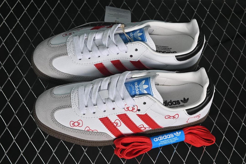 Pair of white and red Hello Kitty-themed sneakers with an extra set of red laces