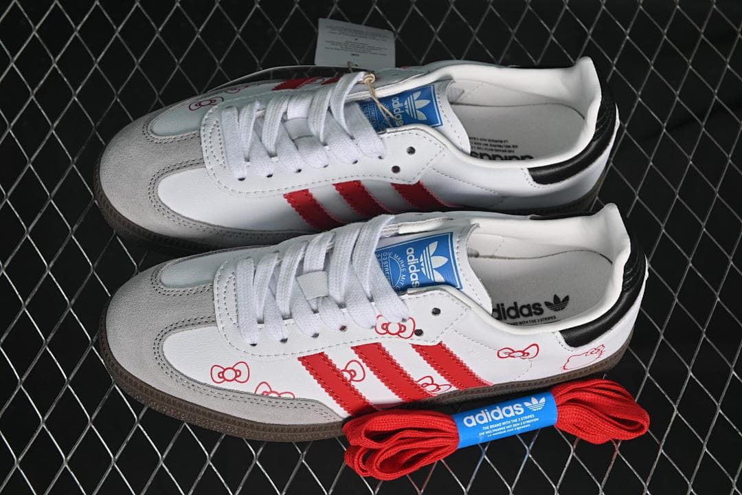 Pair of white and red Hello Kitty-themed sneakers with an extra set of red laces