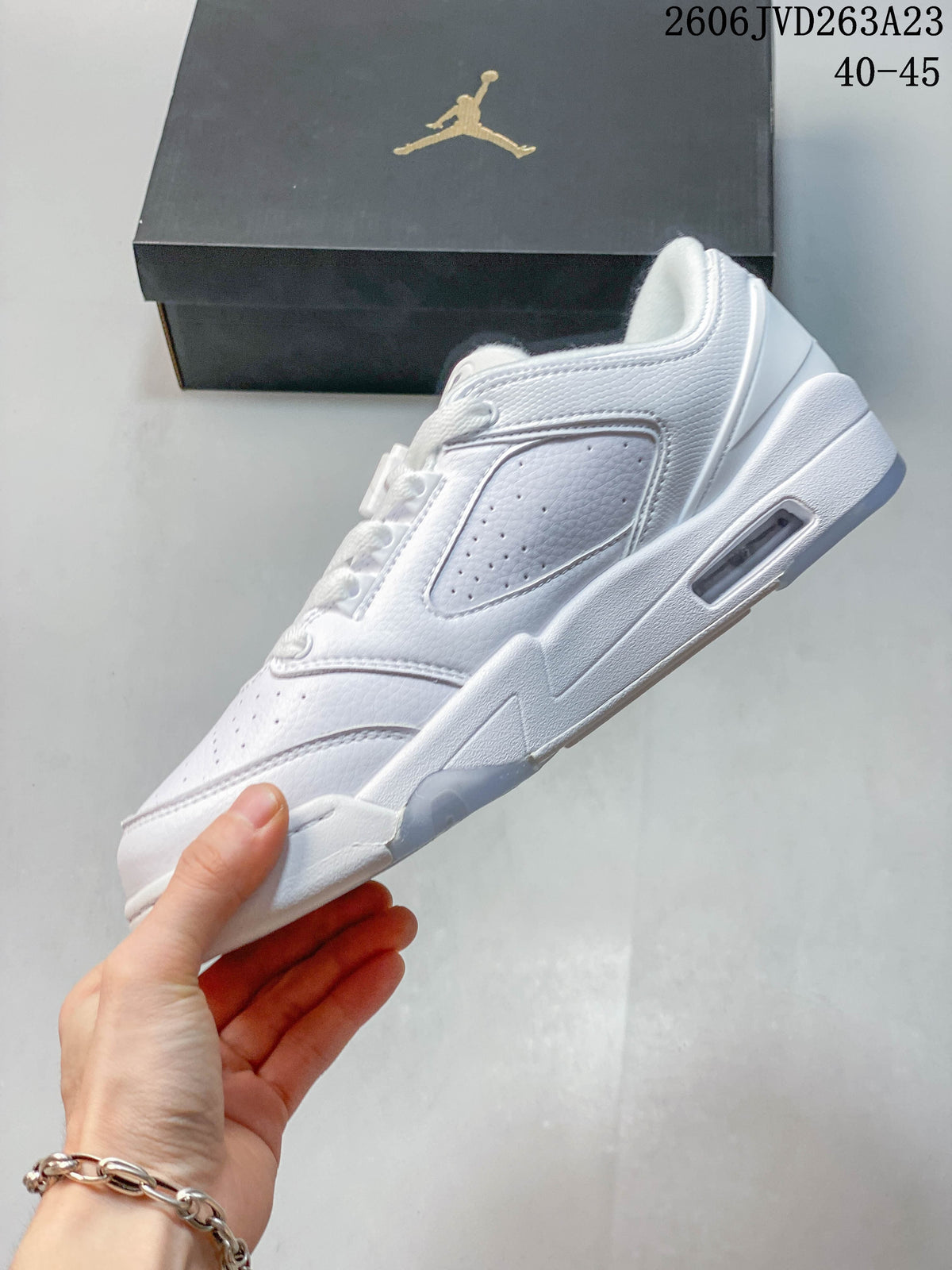 Side profile of a white low-top sneaker with perforated panels