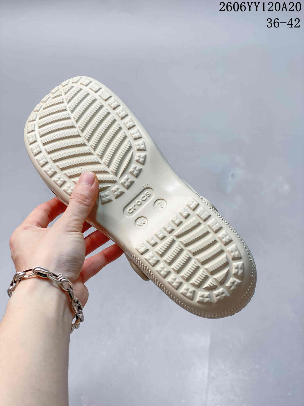 Close view of the cream clog outsole with patterned tread.
