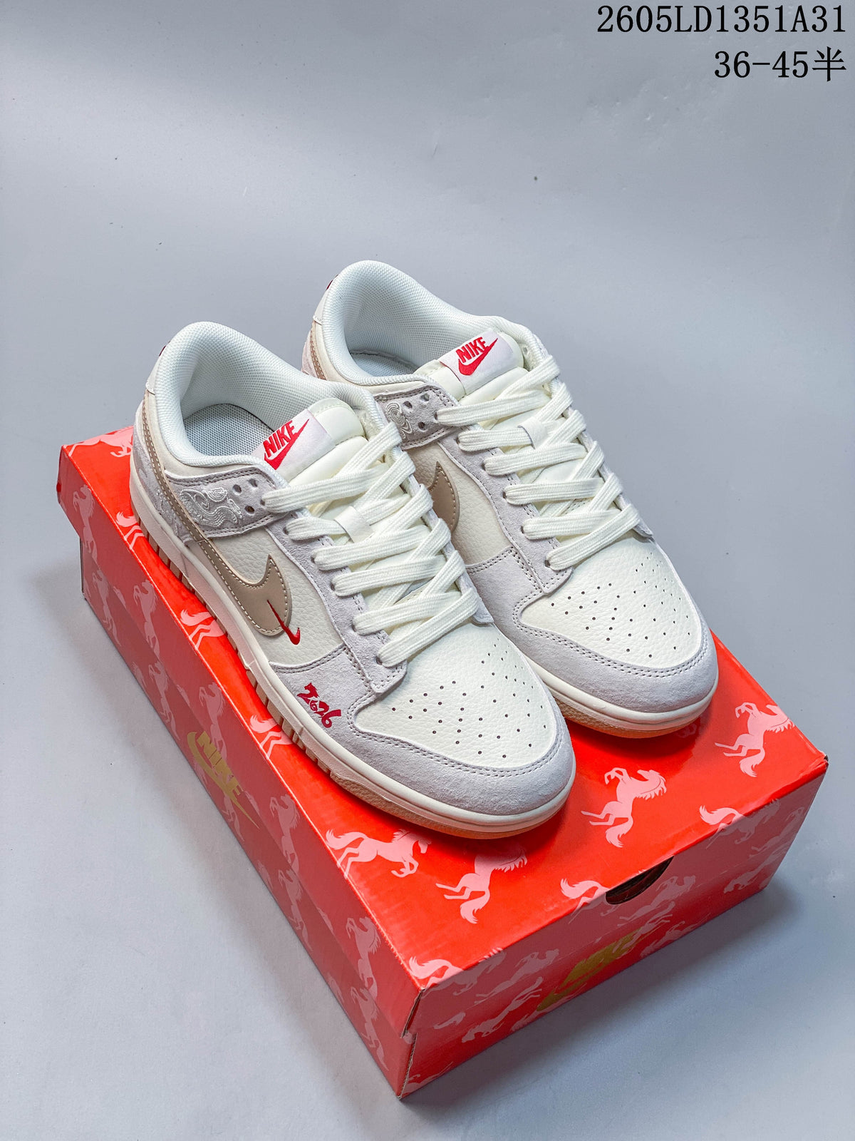 Off-white and taupe Nike Dunk Low sneakers with red accents on a red horse-patterned box