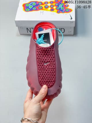 Top view of a red Nike Mind 001 mule with a perforated upper; the box behind it shows a size marking.