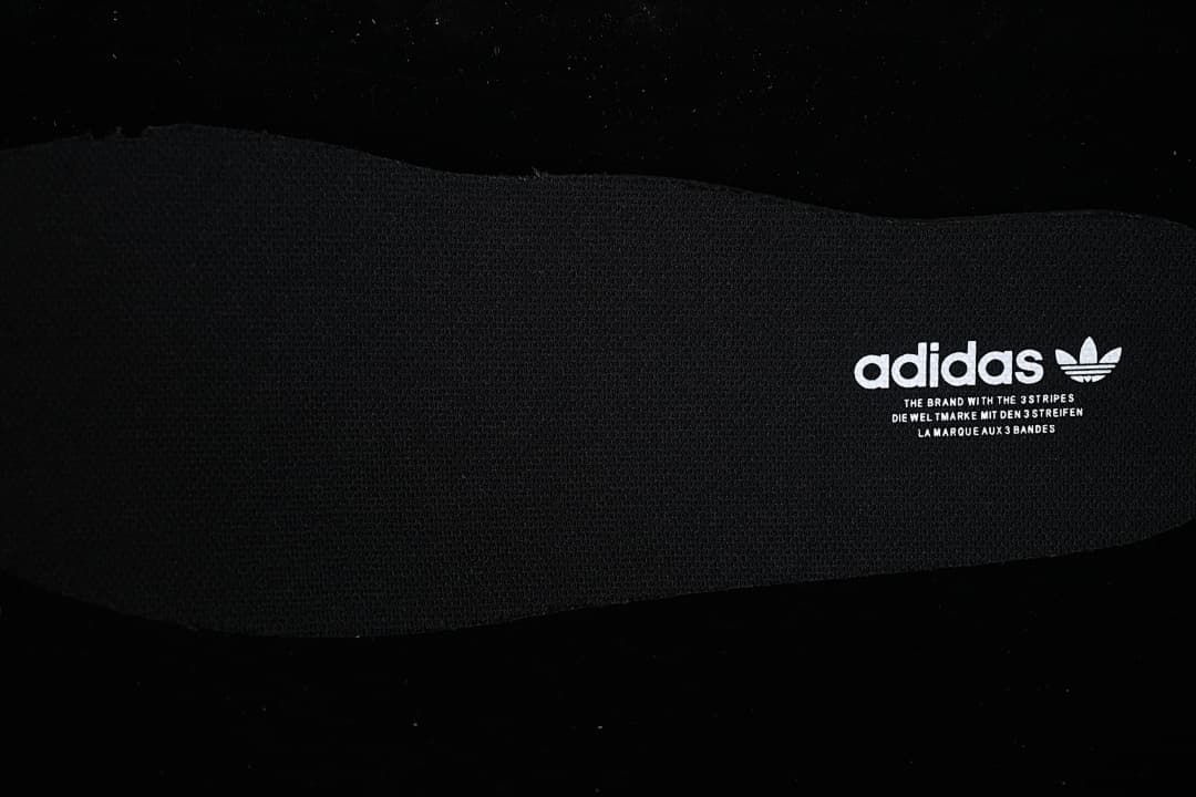 Close-up of the dark insole with adidas branding.