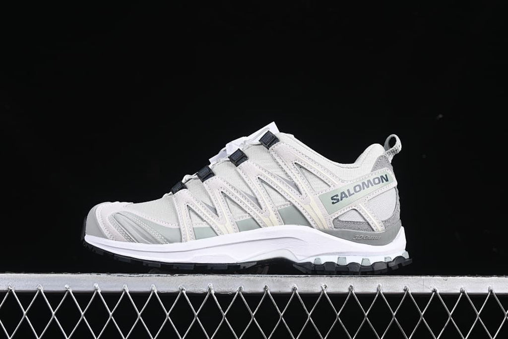 Side view of the white and grey shoe with Salomon branding