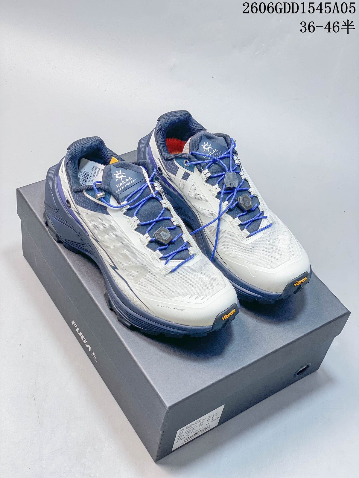 White, blue, and gray Kailas FUGA EX3 BOA shoes displayed on a box.