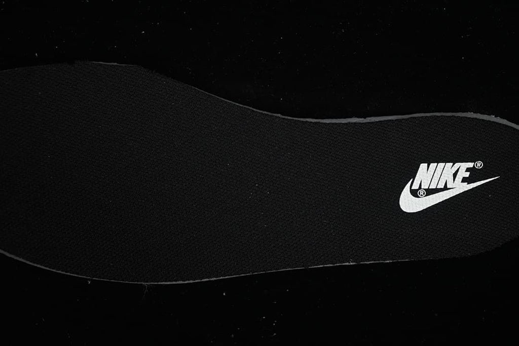 Close-up of a black insole with a white Nike logo
