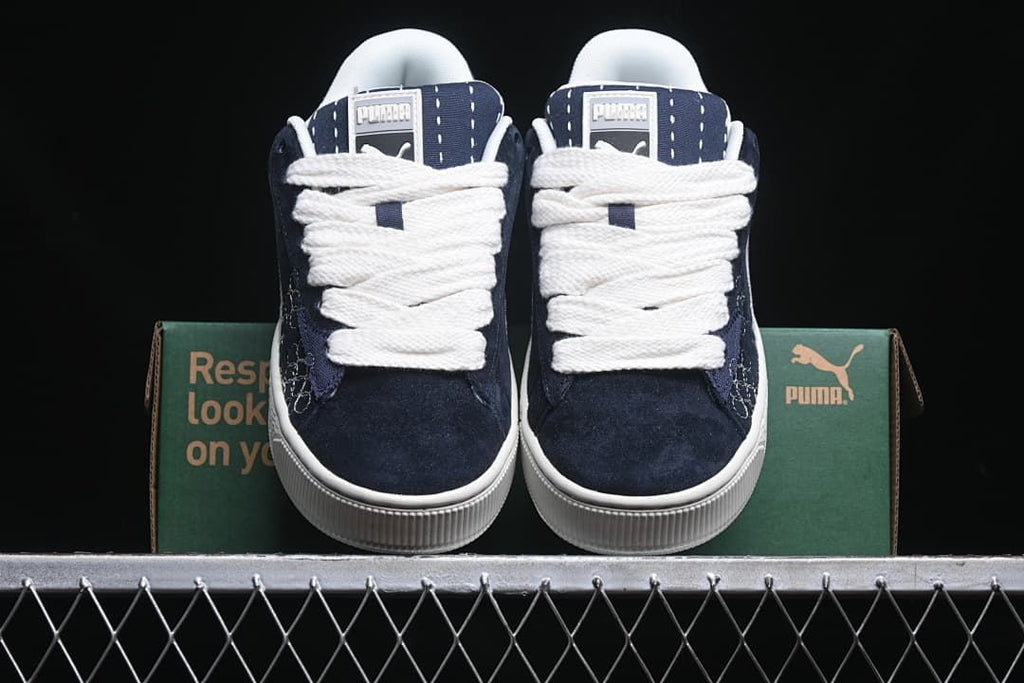 Front view of the pair showing navy uppers and white laces