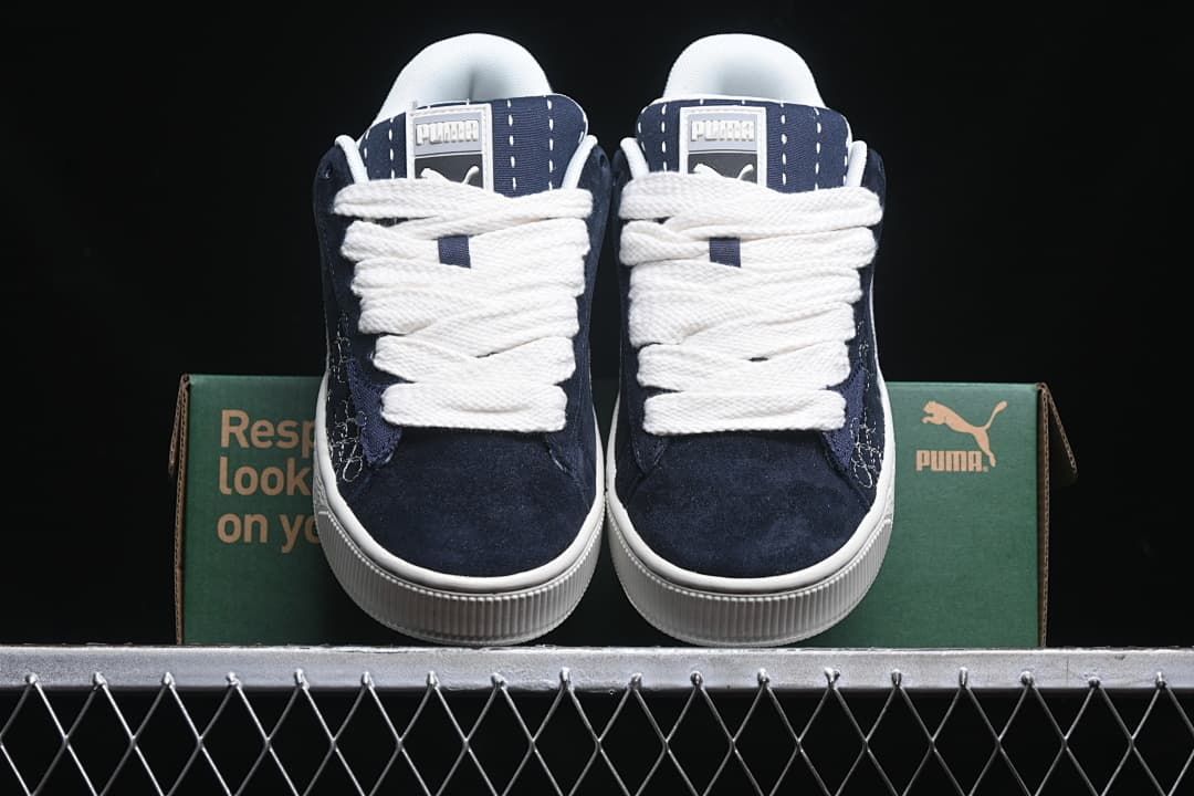 Front view of the pair showing navy uppers and white laces