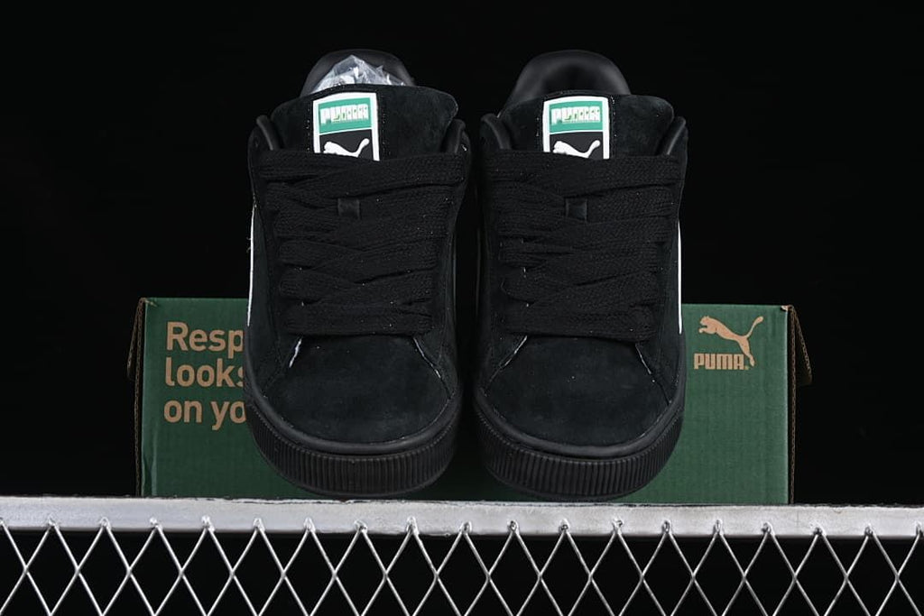 Front view of the pair showing black laces and green-and-white tongue labels.