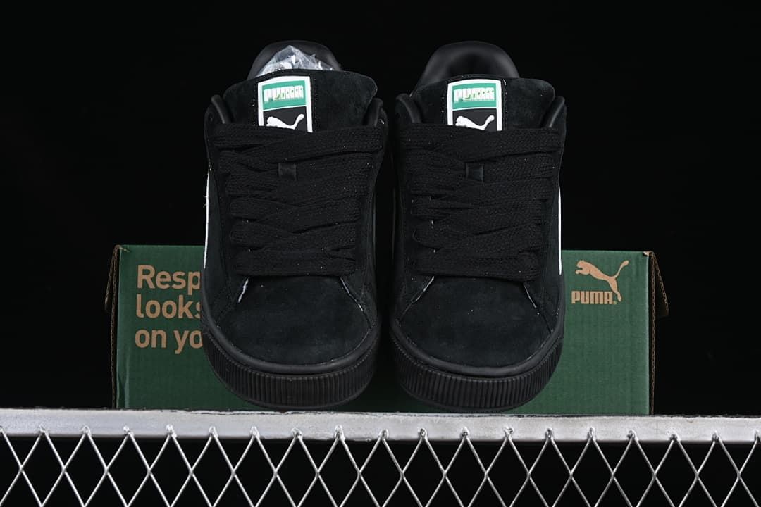 Front view of the pair showing black laces and green-and-white tongue labels.