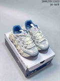 Pair of white and blue FILA Mars sneakers with chunky sculpted soles, shown on a shoebox