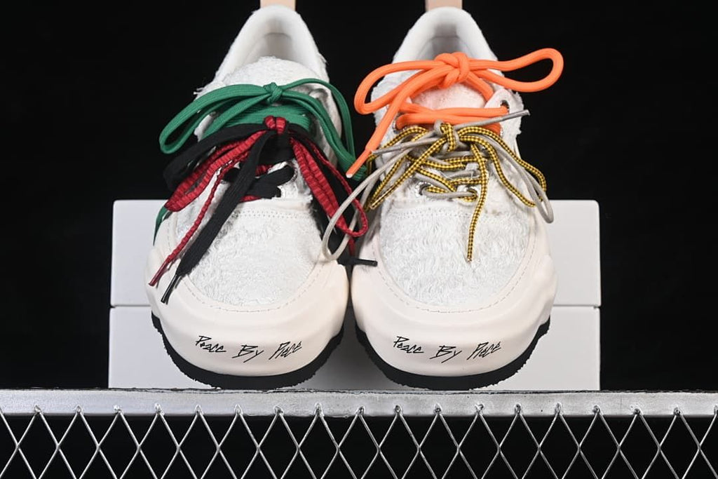 Front view of the pair with contrasting laces and script lettering on the toe.