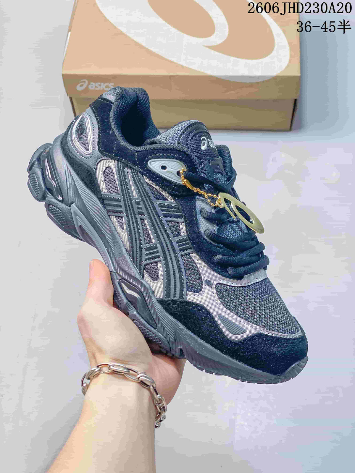 Angled side view of a navy and silver ASICS GEL-NYC 2 sneaker