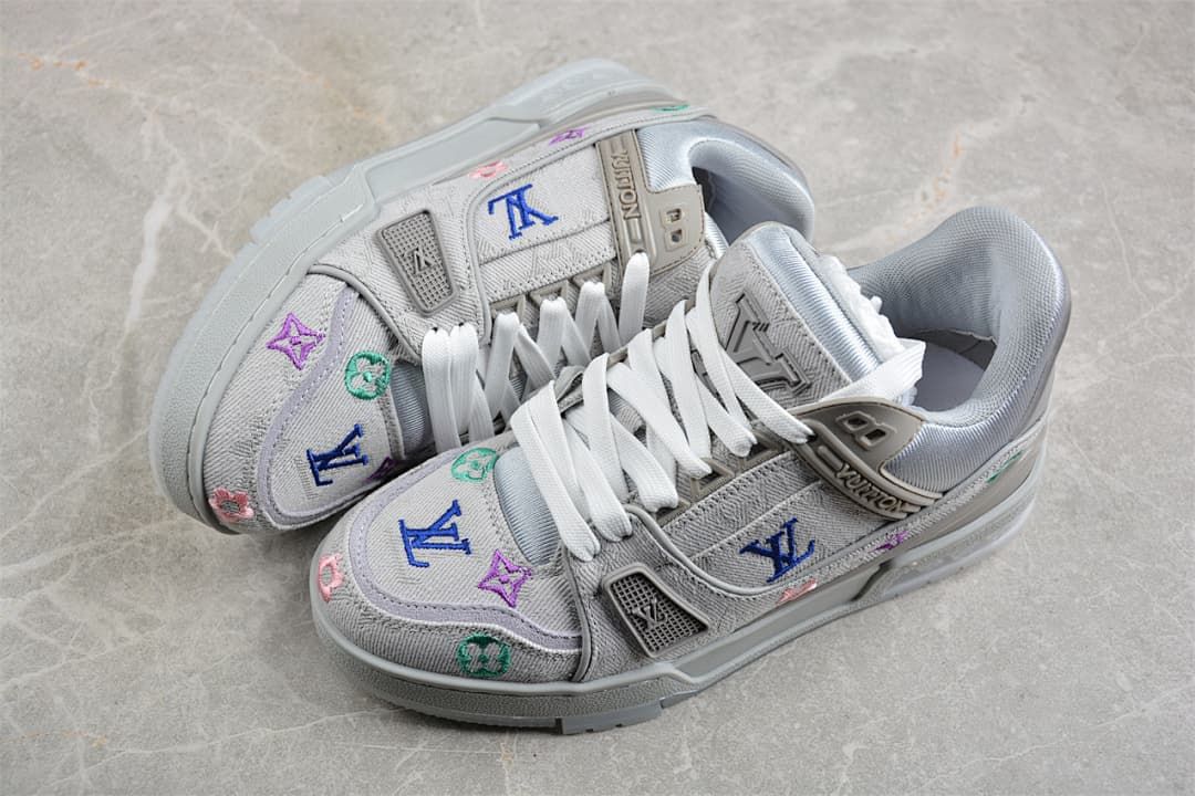 Pair of gray LV Trainer sneakers with white laces and colorful motifs