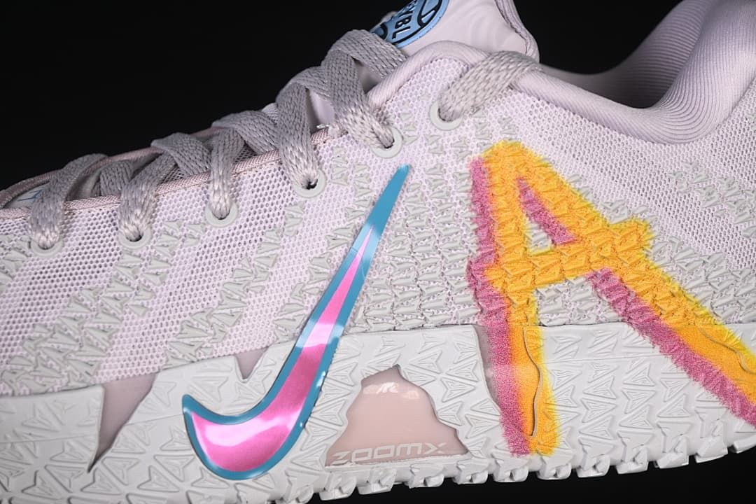 Close-up of the shoe side showing a blue and pink swoosh and multicolor graphic