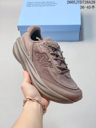 Side view of a taupe-brown New Balance running shoe with mesh upper and sculpted midsole