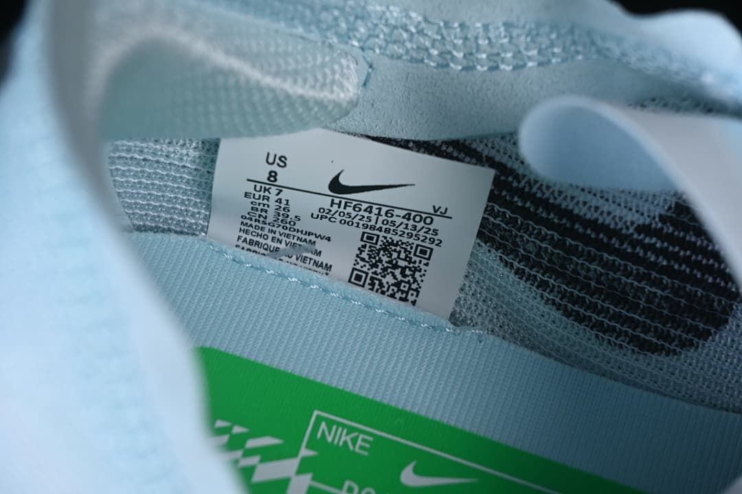 Close-up of shoe size and style label inside the pale blue upper
