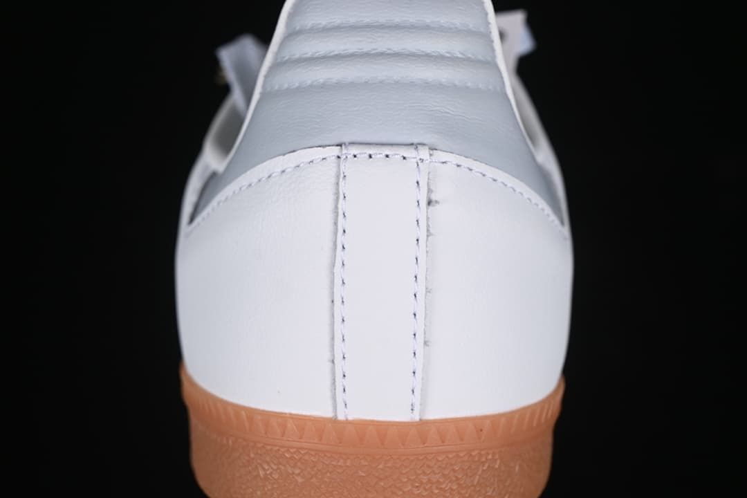 Rear view of the white sneaker and gum-colored outsole