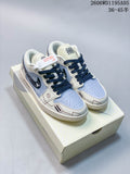 Pair of white and pale blue graphic low-top sneakers with navy laces displayed on a box