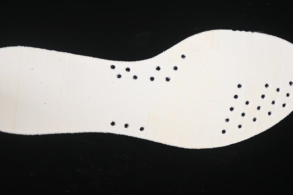 Close-up of the pale outsole with small black perforations