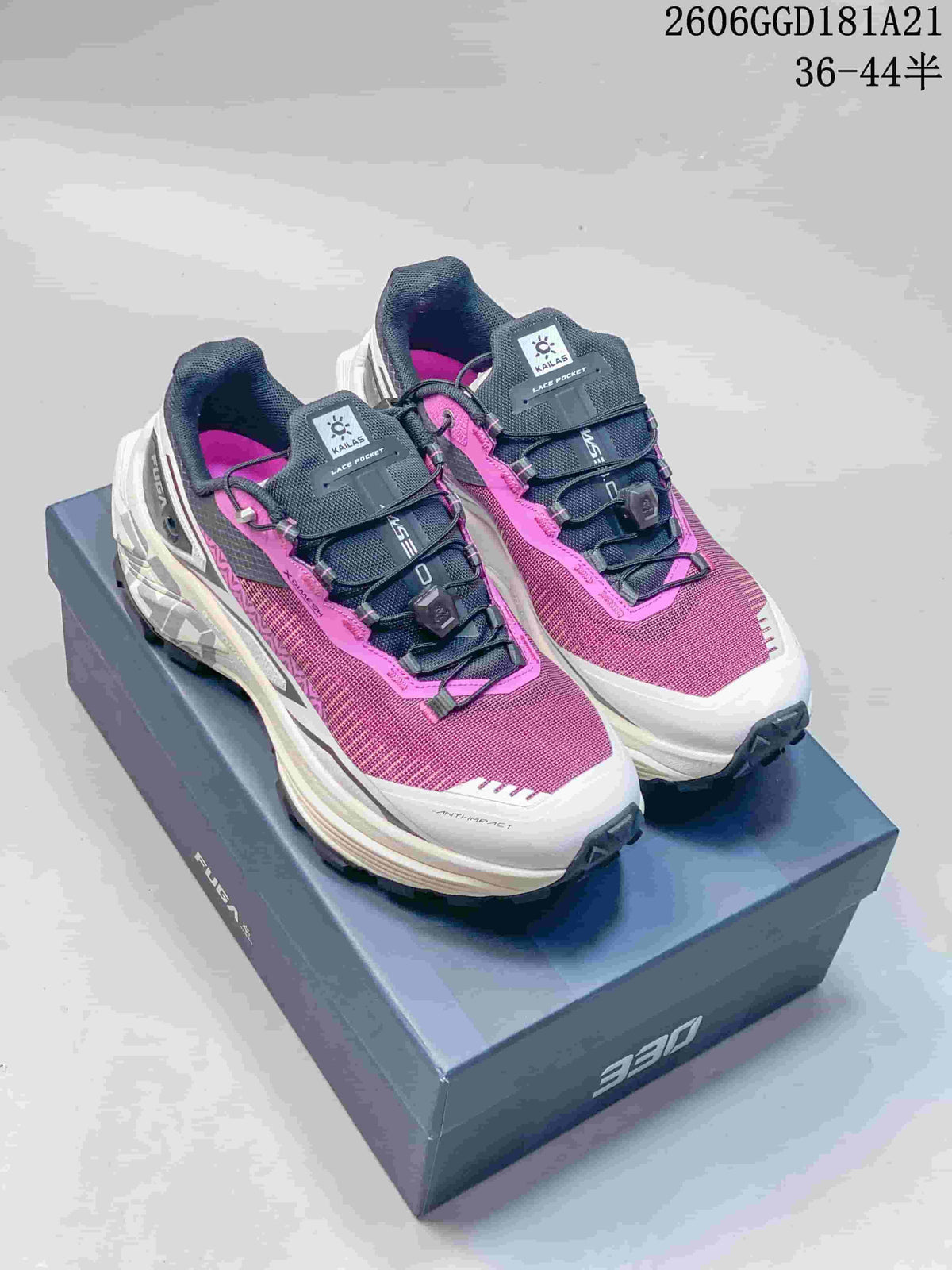 Pair of pink and dark gray Kailas FUGA EX BOA trail shoes on a box