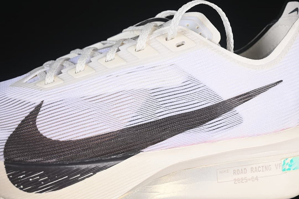 Close-up of the black Swoosh and white upper with fine linear detailing