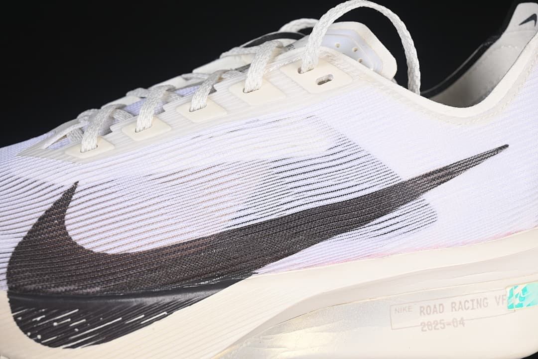 Close-up of the black Swoosh and white upper with fine linear detailing