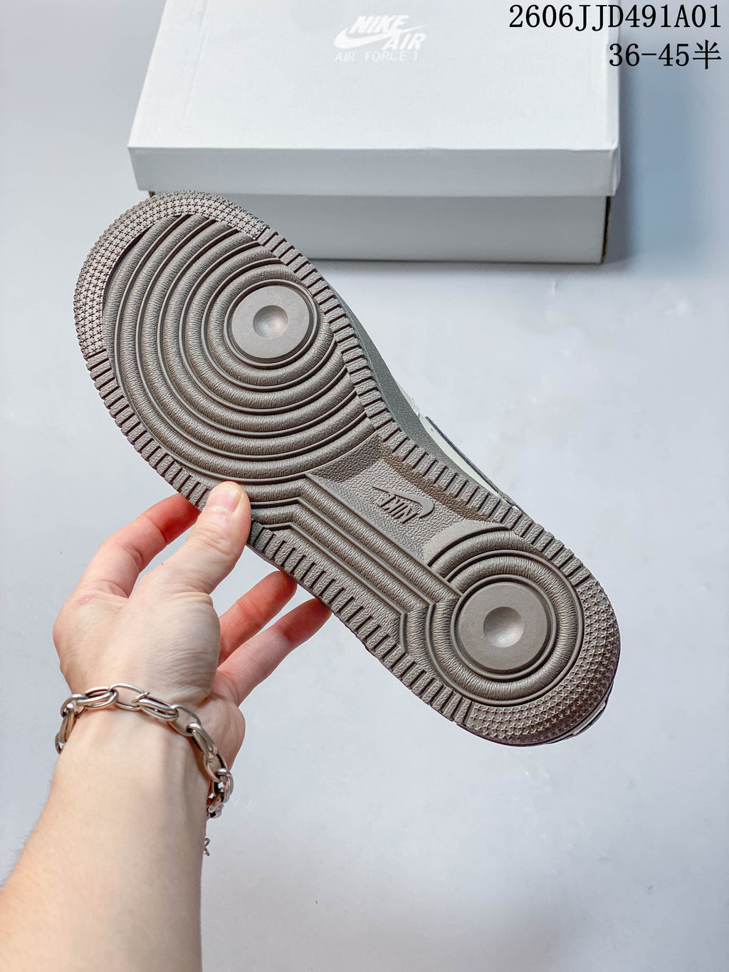 Close-up of the textured taupe outsole with circular tread details