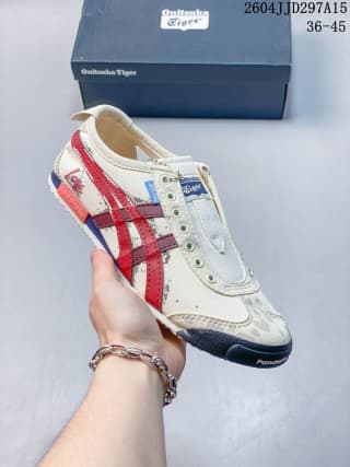 Onitsuka Tiger Mexico 66 sneaker in a white colorway with red side stripes and a dark outsole.
