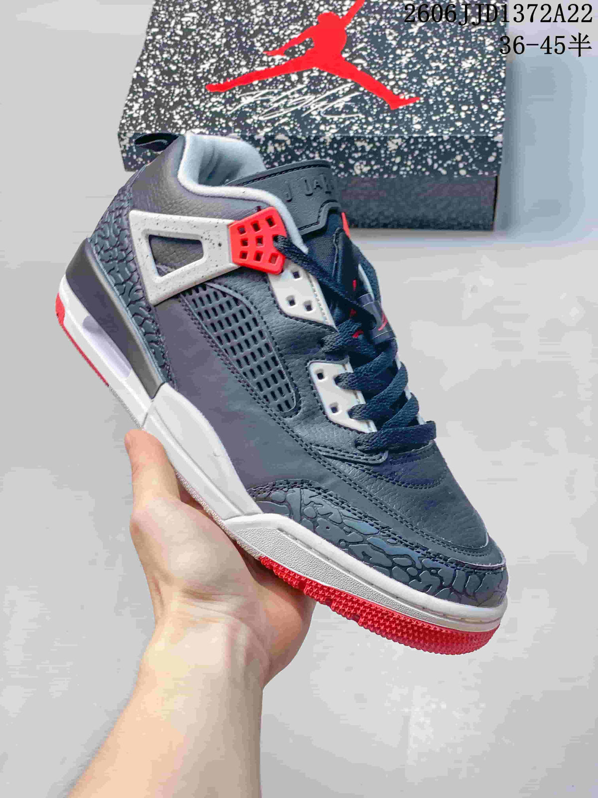 Close side view of a charcoal Jordan Spizike Low sneaker with perforated panels and white-red accents