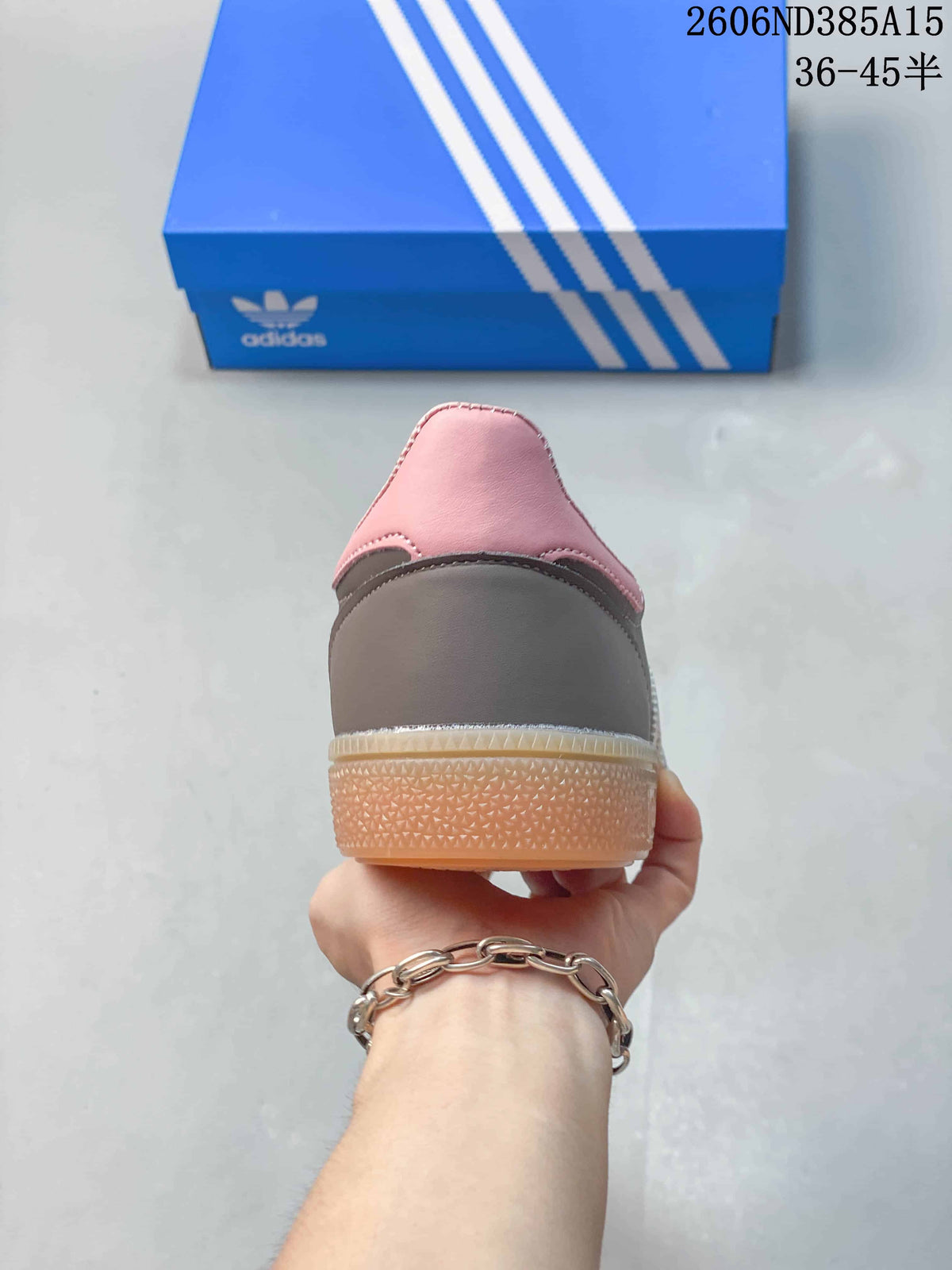 Rear view of the sneaker showing its grey heel panel, pink collar and gum-colored sole.