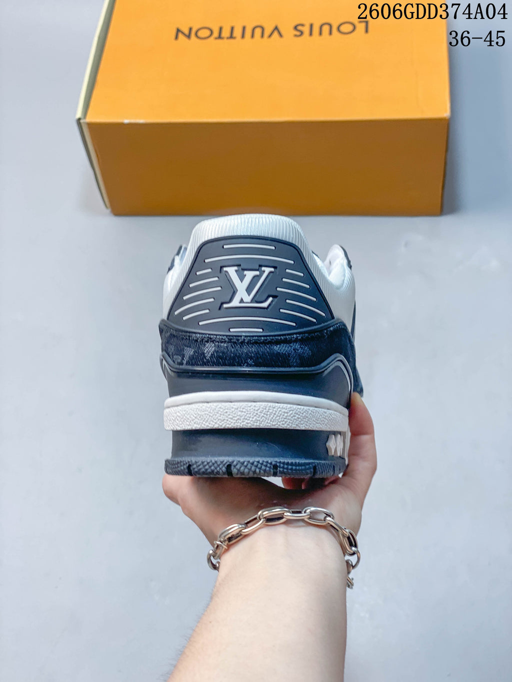 Rear view showing the heel branding and layered panels of a Louis Vuitton Trainer sneaker.