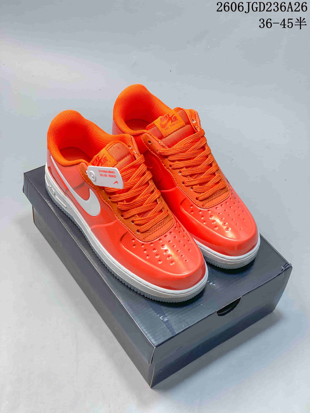Orange Nike Air Force 1 '07 Low sneakers with white side Swooshes and a white midsole