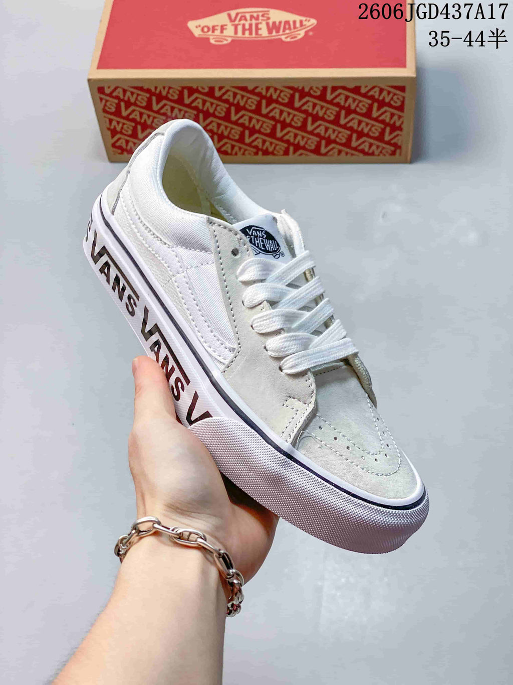 Angled view of the sneaker showing the lace-up upper, side stripe, and printed sole lettering.